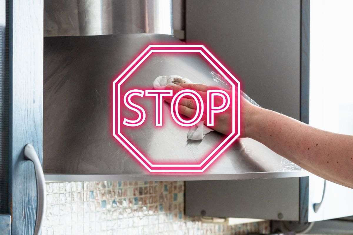 donna pulisce cappa della cucina