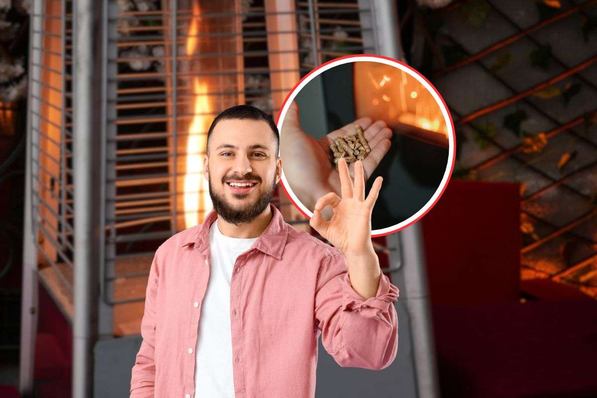 uomo sorridente che fa ok, stufa a pellet e stufa a gas come sfondo