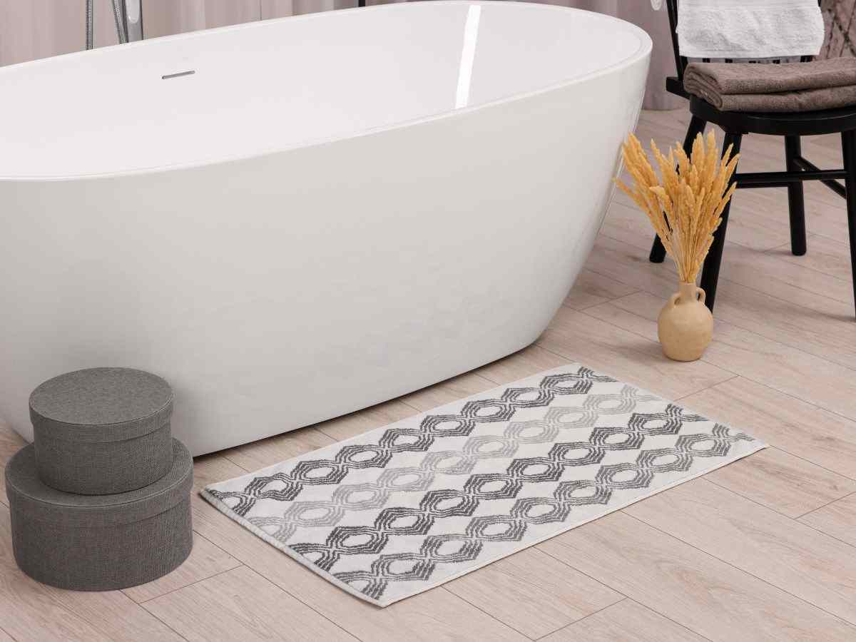 tappetino posto frontale a una vasca da bagno